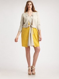 Feminine charm meets a cropped silhouette to give you the quintessential layer with pretty grosgrain trim and three-quarter sleeves for season-appropriate arm coverage.Round neckThree-quarter sleevesGrosgrain trimPleat details at backAbout 26 from shoulder to hem60% cotton/40% acrylicHand washImported Feminine charm meets a cropped silhouette to give you the quintessential layer with pretty grosgrain trim and three-quarter sleeves for season-appropriate arm coverage.Round neckThree-quarter sleevesGrosgrain trimPleat details at backAbout 26 from shoulder to hem60% cotton/40% acrylicHand washImported