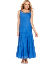Colorful, tribal-inspired beading at the neck of this Jones New York dress punctuates the bold hue of its beautifully tiered maxi silhouette. Colorful, tribal-inspired beading at the neck of this Jones New York dress punctuates the bold hue of its beautifully tiered maxi silhouette.
