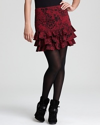 A rich hue and ruffled hem enliven an animal-print DKNY skirt, layered over sheer tights for a roaring fashion statement. A rich hue and ruffled hem enliven an animal-print DKNY skirt, layered over sheer tights for a roaring fashion statement.
