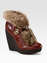 A signature medallion shines against this leather ankle boot with faux fur trim and an elevated wedge. Rubber wedge, 4½ (115mm)Rubber platform, 1 (25mm)Compares to a 3½ heel (90mm)Leather upper with faux fur trimLeather liningRubber solePadded insoleImported A signature medallion shines against this leather ankle boot with faux fur trim and an elevated wedge. Rubber wedge, 4½ (115mm)Rubber platform, 1 (25mm)Compares to a 3½ heel (90mm)Leather upper with faux fur trimLeather liningRubber solePadded insoleImported