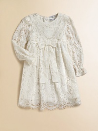 Nothing's lovelier for your little girl than the airy swirls of this lavish lace frock with a flowing skirt and a scalloped hem.Round necklineLong sleeves with ruffled cuffsEmpire waist with bowBack button closeSilk/cotton liningRayon/cotton/nylon/silkDry cleanImported Please note: Number of buttons may vary depending on size ordered. 