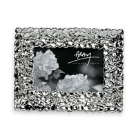 This hydrangea frame from renown metal designer Michael Aram fits perfectly with any home décor. The silverplated and tarnish resistant frame holds one 4x6 photograph. Frame measures 8.5 x 6.5. This hydrangea frame from renown metal designer Michael Aram fits perfectly with any home décor. The silverplated and tarnish resistant frame holds one 4x6 photograph. Frame measures 8.5 x 6.5.