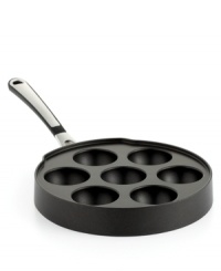 Simply slip into the flavorful filled goodness of a timeless treat. Everyone's favorite breakfast fare gets even tastier with irresistible fillings that greet your sweet tooth with just what it craves. Crafted from medium-gauge hard-anodized aluminum, the Ebelskiver pan requires little to no use of oil and provides an even heating that produces golden, brown puff pancakes every time. 10-year warranty. Simply slip into the flavorful filled goodness of a timeless treat. Everyone's favorite breakfast fare gets even tastier with irresistible fillings that greet your sweet tooth with just what it craves. Crafted from medium-gauge hard-anodized aluminum, the Ebelskiver pan requires little to no use of oil and provides an even heating that produces golden, brown puff pancakes every time. 10-year warranty.