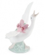 With her beak to the sky and a bouquet of orchids in tow, this graceful duck is on the move in magnificent Lladro porcelain.