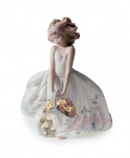 Flower girl. With a basket full of blooms and a pretty gown of exquisite porcelain, this sweet Lladro figurine recalls a girl's first wedding or special Easter moment.