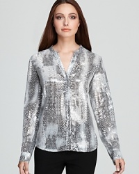 Subtle sequins enliven a snakeskin-print Calvin Klein blouse for a riveting style choice. Play up the tonal palette with sleek sliver accents and embrace untamed glamour. Subtle sequins enliven a snakeskin-print Calvin Klein blouse for a riveting style choice. Play up the tonal palette with sleek sliver accents and embrace untamed glamour.