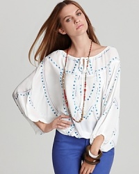 Billowing batwing sleeves and a colorful embroidered pattern impart this sheer Shiloh770 top with a free-spirited elegance. Billowing batwing sleeves and a colorful embroidered pattern impart this sheer Shiloh770 top with a free-spirited elegance.