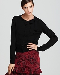 It's all in the details with this DKNY cardigan. A dainty bow at the neckline lends an unabashedly feminine finish to the classic silhouette. It's all in the details with this DKNY cardigan. A dainty bow at the neckline lends an unabashedly feminine finish to the classic silhouette.