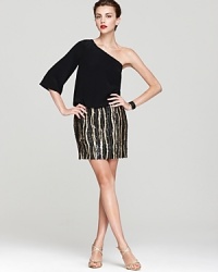 A fitted, sequined skirt lends chic contrast against an effortless, blouson bodice on this one shoulder Aidan Mattox dress. A fitted, sequined skirt lends chic contrast against an effortless, blouson bodice on this one shoulder Aidan Mattox dress.