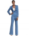 A ruffled collar and a belted waist accent the unique cut of Anne Klein's petite suit. Fashionably flared trousers complete the look.