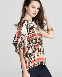 This season, it's all about a good dye job, and this VINCE CAMUTO kimono top embodies the trend with a vivid tie-dye pattern and billowy sleeves. This season, it's all about a good dye job, and this VINCE CAMUTO kimono top embodies the trend with a vivid tie-dye pattern and billowy sleeves.