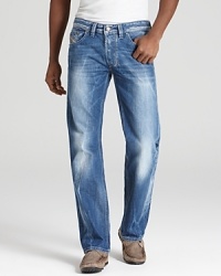 A straight jean with a light blue rinse and contrast sandblast fading and bleaching along the leg and seat. A straight jean with a light blue rinse and contrast sandblast fading and bleaching along the leg and seat.