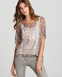 Channel modern bohemian style in this Sam & Lavi top, flaunting an eclectic print and billowy high/low hem. Channel modern bohemian style in this Sam & Lavi top, flaunting an eclectic print and billowy high/low hem.