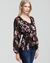 Blouson sleeves and a drawstring waist cultivate feminine grace on this painterly, floral-print Madison Marcus top.