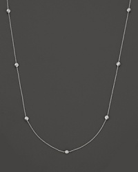 A white gold necklace with seven bezel-set diamond stations; with signature ruby accent. Designed by Roberto Coin. A white gold necklace with seven bezel-set diamond stations; with signature ruby accent. Designed by Roberto Coin.
