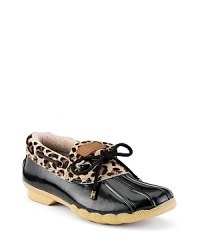 Classic rain shoes with a wild twist. Rubber shoes with leopard print haircalf cuffs and a contrast bow detail. Classic rain shoes with a wild twist. Rubber shoes with leopard print haircalf cuffs and a contrast bow detail.