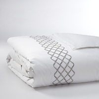 For lovers of fine bed dressing, Ogee Embroidery emulates understated opulence. A sophisticated, contemporary approach to a classic ogee design. Satin stitch and twill texture embroidery create a sleek vertical line. Featured in pewter against white Egyptian cotton sateen. For lovers of fine bed dressing, Ogee Embroidery emulates understated opulence. A sophisticated, contemporary approach to a classic ogee design. Satin stitch and twill texture embroidery create a sleek vertical line. Featured in pewter against white Egyptian cotton sateen.
