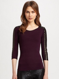 Strikingly fitted top has intricate seaming and urban-cool, leather-trimmed sleeves. RoundneckThree-quarter, leather-trim sleevesRayon with leather trimDry clean with leather specialistImportedModel shown is 5'9½ (176cm) wearing US size Small.This style runs true to size. We recommend ordering your usual size for a standard fit. Strikingly fitted top has intricate seaming and urban-cool, leather-trimmed sleeves. RoundneckThree-quarter, leather-trim sleevesRayon with leather trimDry clean with leather specialistImportedModel shown is 5'9½ (176cm) wearing US size Small.This style runs true to size. We recommend ordering your usual size for a standard fit.