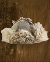 An on-trend trapper hat in a hearty intarsia-knit design is accented with luxe faux fur, creating a cool hipster accent in chilly weather. An on-trend trapper hat in a hearty intarsia-knit design is accented with luxe faux fur, creating a cool hipster accent in chilly weather.