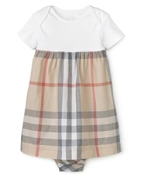 A youthful empire waist silhouette makes this Burberry dress a classic choice for dressing the most stylish little girls. A youthful empire waist silhouette makes this Burberry dress a classic choice for dressing the most stylish little girls.