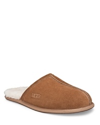 Suede mule style slipper, fully lined in sheepskin. Genuine sheepskin sockliner that naturally wicks moisture away and keeps your feet dry. Lightweight, sueded bottom with embossed logo. Suede mule style slipper, fully lined in sheepskin. Genuine sheepskin sockliner that naturally wicks moisture away and keeps your feet dry. Lightweight, sueded bottom with embossed logo.