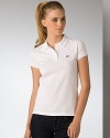 The iconic sporty style rendered in a soft stretch cotton pique. Wear this wardrobe essential everywhere - from the court to dinner out. Two-button placket, short sleeves with banded cuffs, split seam hem. Signature crocodile appliqué at chest. Stretch pique fabric allows for a comfortable form-fitting look and feel.