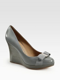 A sculpted wedge takes this bow-trimmed leather pump to new style heights. Stacked wedge, 4 (100mm)Stacked platform, ½ (15mm)Compares to a 3½ heel (90mm)Leather upper with grosgrain ribbon trimLeather lining and solePadded insoleMade in Italy A sculpted wedge takes this bow-trimmed leather pump to new style heights. Stacked wedge, 4 (100mm)Stacked platform, ½ (15mm)Compares to a 3½ heel (90mm)Leather upper with grosgrain ribbon trimLeather lining and solePadded insoleMade in Italy
