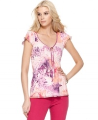 Brightened by a botanically-inspired print, this Calvin Klein Jeans top is full of feminine touches, from the flutter sleeves to the graceful tie at the neck. A hint of smocking below the bust ensures a flattering fit. Brightened by a botanically-inspired print, this Calvin Klein Jeans top is full of feminine touches, from the flutter sleeves to the graceful tie at the neck. A hint of smocking below the bust ensures a flattering fit.