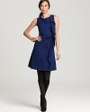 Rolling ruffles lend playful spirit to a flared Lafayette 148 New York dress for classic feminine charm.