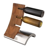 Designer Neil Cohen turned the hum-drum concept of a wine rack into an objet d'art by joining two curves and conceiving the ingenious idea that bottles can be stored horizontally by their necks only. The result is a conversation piece of startling originality. The rack has a base formed of Nambé alloy, metal that polishes to a silver-like luster. Curving in the opposite direction and holding three standard 750-liter bottles is a narrower piece of warm-toned acacia wood, a dense, durable hardwood with finely patterned grain. Designer Neil Cohen turned the hum-drum concept of a wine rack into an objet d'art by joining two curves and conceiving the ingenious idea that bottles can be stored horizontally by their necks only. The result is a conversation piece of startling originality. The rack has a base formed of Nambé alloy, metal that polishes to a silver-like luster. Curving in the opposite direction and holding three standard 750-liter bottles is a narrower piece of warm-toned acacia wood, a dense, durable hardwood with finely patterned grain.
