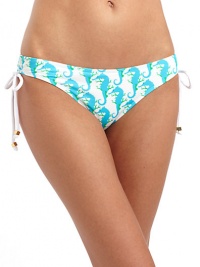 THE LOOKBright sea horse patternElastic waist and leg openingsDrawstring side ties with metal hardwareTHE MATERIAL80% nylon/20% spandexFully linedCARE & ORIGINHand washMade in USAPlease note: Bikini top sold separately. THE LOOKBright sea horse patternElastic waist and leg openingsDrawstring side ties with metal hardwareTHE MATERIAL80% nylon/20% spandexFully linedCARE & ORIGINHand washMade in USAPlease note: Bikini top sold separately.