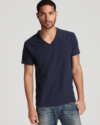 V-neck tee with allover slub texture and raw edges. V-neck tee with allover slub texture and raw edges.