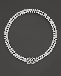 Double stranded necklace with a diamond bow clasp closure. Double stranded necklace with a diamond bow clasp closure.