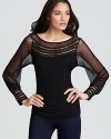 Exquisite, feminine details enrich this sassy sheer top by GUESS.
