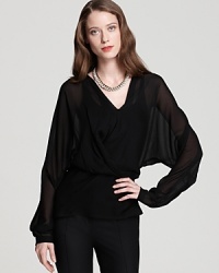 Bring your wardrobe back to black in an effortless Halston Heritage blouse, touting artful draping and sheer styling for a decadently dark style statement. Bring your wardrobe back to black in an effortless Halston Heritage blouse, touting artful draping and sheer styling for a decadently dark style statement.