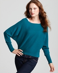 This BCBGMAXAZRIA sweater plays with proportions, flaunting a stylish cropped silhouette and drapey dolman sleeves. This BCBGMAXAZRIA sweater plays with proportions, flaunting a stylish cropped silhouette and drapey dolman sleeves.