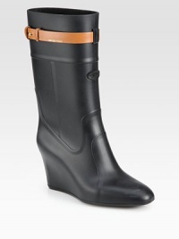 A hidden wedge elevates this rainy weather essential of durable rubber, topped off with a contrasting leather strap. Hidden wedge, 3½ (90mm)Shaft, 10Leg circumference, 13Rubber and leather upperPull-on style with adjustable leather metal-tab strap Leather liningRubber solePadded insoleMade in Italy A hidden wedge elevates this rainy weather essential of durable rubber, topped off with a contrasting leather strap. Hidden wedge, 3½ (90mm)Shaft, 10Leg circumference, 13Rubber and leather upperPull-on style with adjustable leather metal-tab strap Leather liningRubber solePadded insoleMade in Italy