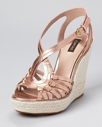 A metallic masterpiece from Joan & David--the Dreena sandals boast knotted details and a raffia-wrapped wedge. A metallic masterpiece from Joan & David--the Dreena sandals boast knotted details and a raffia-wrapped wedge.
