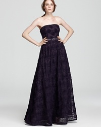 With a sparkling embellished waist, Adrianna Papell's gown stuns in a strapless silhouette. With a sparkling embellished waist, Adrianna Papell's gown stuns in a strapless silhouette.