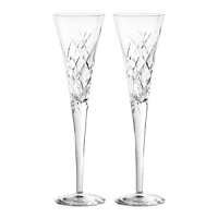 Featuring an updated version of the popular Duchesse pattern. Elegant toasting flute pair for celebrations. Produced in full lead crystal and designed by Vera Wang.