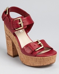 Bold buckles make an impression on KORS Michael Kors' Newman sandals, a chunky silhouette rendered in delectable cinnabar-hued leather and finished with a natural cork sole. Bold buckles make an impression on KORS Michael Kors' Newman sandals, a chunky silhouette rendered in delectable cinnabar-hued leather and finished with a natural cork sole.