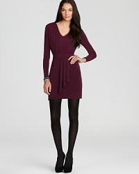 A perfect look from sunrise to sunset, this slinky knit BCBGeneration dress reveals a draped faux wrap skirt that falls above the knee in a flattering stretch fabric. A perfect look from sunrise to sunset, this slinky knit BCBGeneration dress reveals a draped faux wrap skirt that falls above the knee in a flattering stretch fabric.