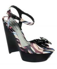 Pretty prints stacked tall make the cutest sandals. Bebe's Florenza platform wedge sandals feature a black patent bow on the toe and matching ankle strap. Pretty prints stacked tall make the cutest sandals. Bebe's Florenza platform wedge sandals feature a black patent bow on the toe and matching ankle strap.