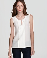 A pleated front panel stuns against a subtly sheer kate spade new york top, finished with an alluring slit neckline for a feminine twist on the 9-to-5 essential. A pleated front panel stuns against a subtly sheer kate spade new york top, finished with an alluring slit neckline for a feminine twist on the 9-to-5 essential.