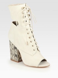 Unexpected cutouts and a textured snake-print heel add signature style to this lace-up ankle boot in buttery leather. Snake-print leather heel, 3¼ (80mm)Leather upperOpen toeSide zipLeather lining and solePadded insoleImported Unexpected cutouts and a textured snake-print heel add signature style to this lace-up ankle boot in buttery leather. Snake-print leather heel, 3¼ (80mm)Leather upperOpen toeSide zipLeather lining and solePadded insoleImported