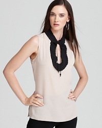 A study in contrasts, this Anne Klein blouse offsets a demure silhouette with a dramatic ruffled keyhole for a modern feminine statement. A study in contrasts, this Anne Klein blouse offsets a demure silhouette with a dramatic ruffled keyhole for a modern feminine statement.