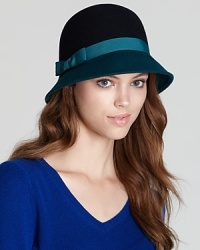 Take the colorblocking trend to the top with August Accessories' cloche, featuring a contrast brim and ribbon detail. Take the colorblocking trend to the top with August Accessories' cloche, featuring a contrast brim and ribbon detail.