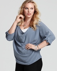 This flowing Eileen Fisher draped silk shirt lets you choose the length of your sleeves with an adjustable buttoned roll tab. Team the silk piece with staple black pants for an instant infusion of effortless chic. This flowing Eileen Fisher draped silk shirt lets you choose the length of your sleeves with an adjustable buttoned roll tab. Team the silk piece with staple black pants for an instant infusion of effortless chic.