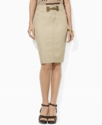 An elegant pencil skirt silhouette is crafted in neutral denim and finished with a heritage faux-suede buckle at the front. An elegant pencil skirt silhouette is crafted in neutral denim and finished with a heritage faux-suede buckle at the front.