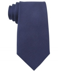 A solid statement. Score a singular look with this silk tie from Tommy Hilfiger. A solid statement. Score a singular look with this silk tie from Tommy Hilfiger.